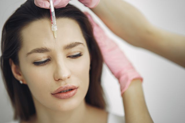 Female getting an injection on the forehead